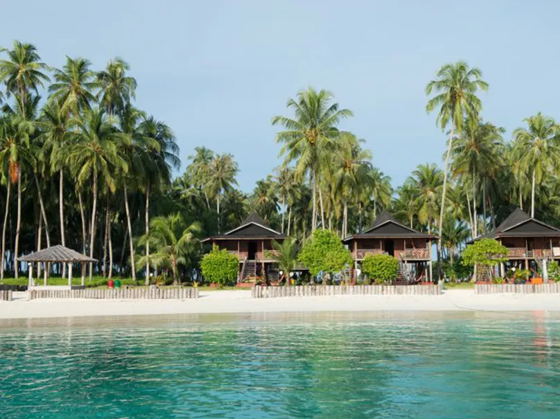 Scenic Maldives coastline with rolling waves and golden sunlight – Atoll Travel