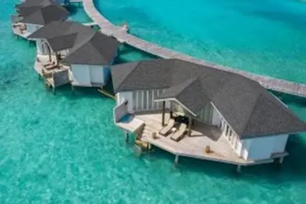 Aerial view of Cinnamon Dhonveli Maldives overwater suites and lagoon – Atoll Travel