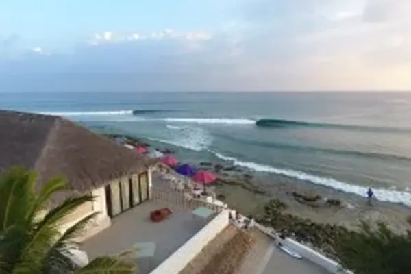 Drone shot of surfers waiting for waves near tropical reef, Maldives – Atoll Travel