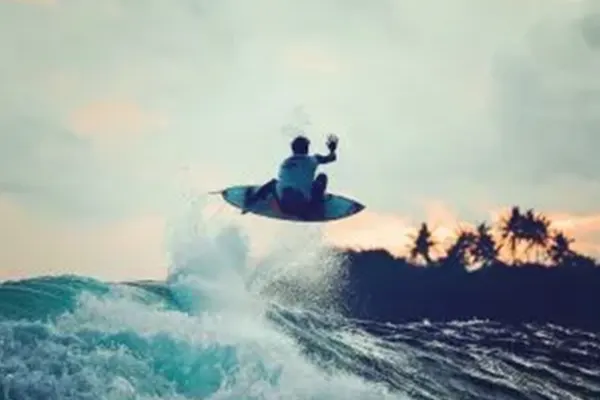 Surfer Gabriel Medina performing top turn on wave at Pasta Point, Maldives – Atoll Travel