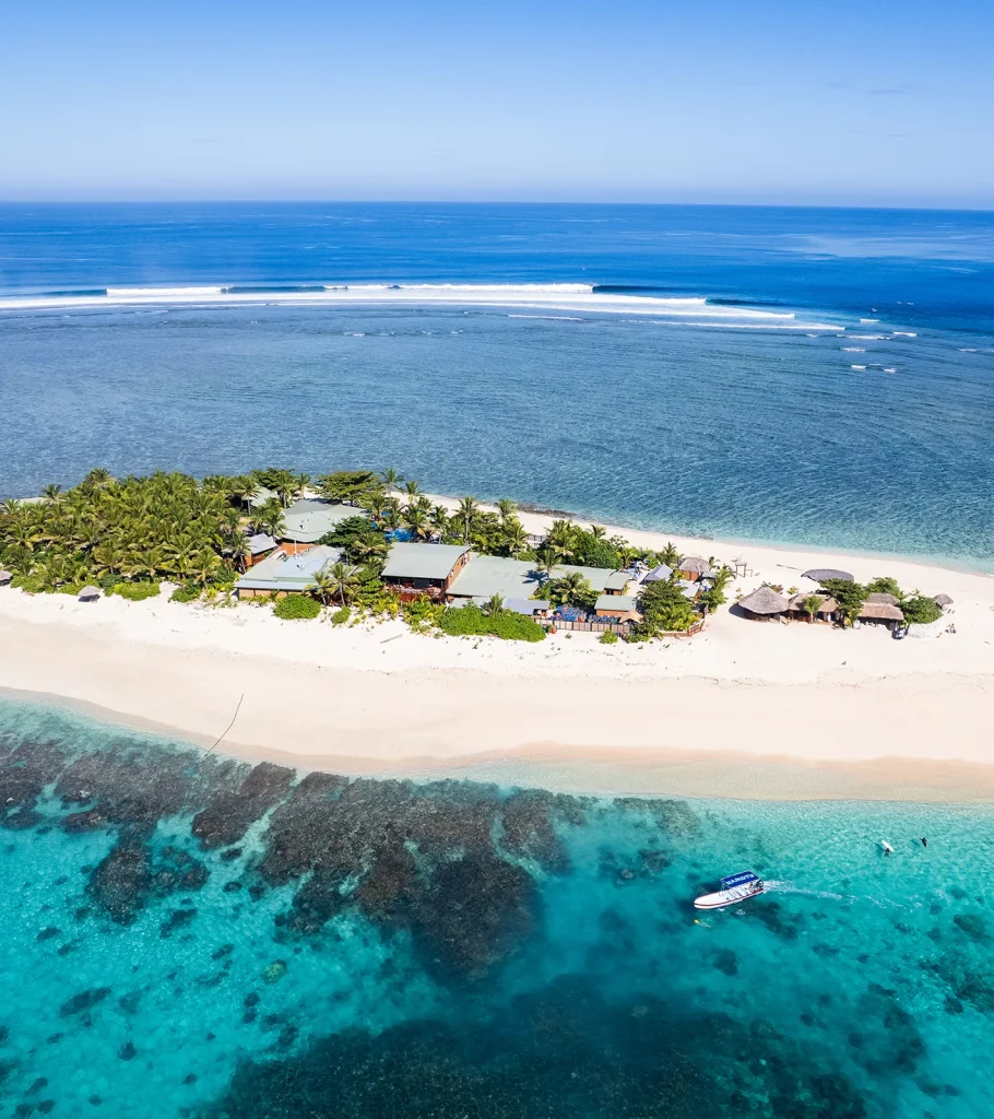 Action shot of surfer carving on a large Maldives wave – Atoll Travel