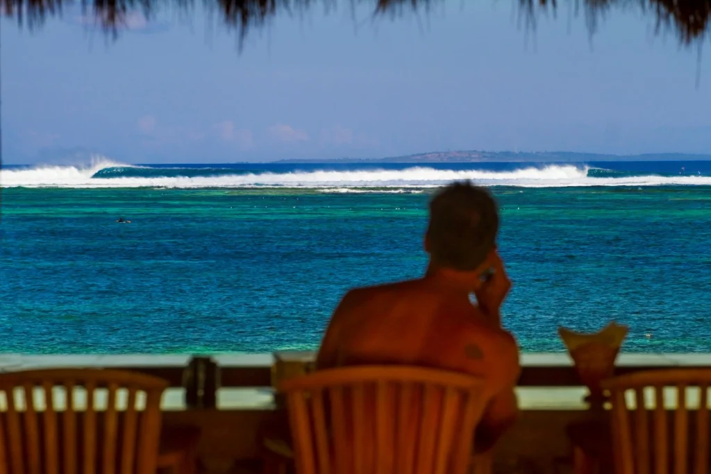 Surfers watching waves from the bar at Nemberala surf spot, West Timor – Atoll Travel