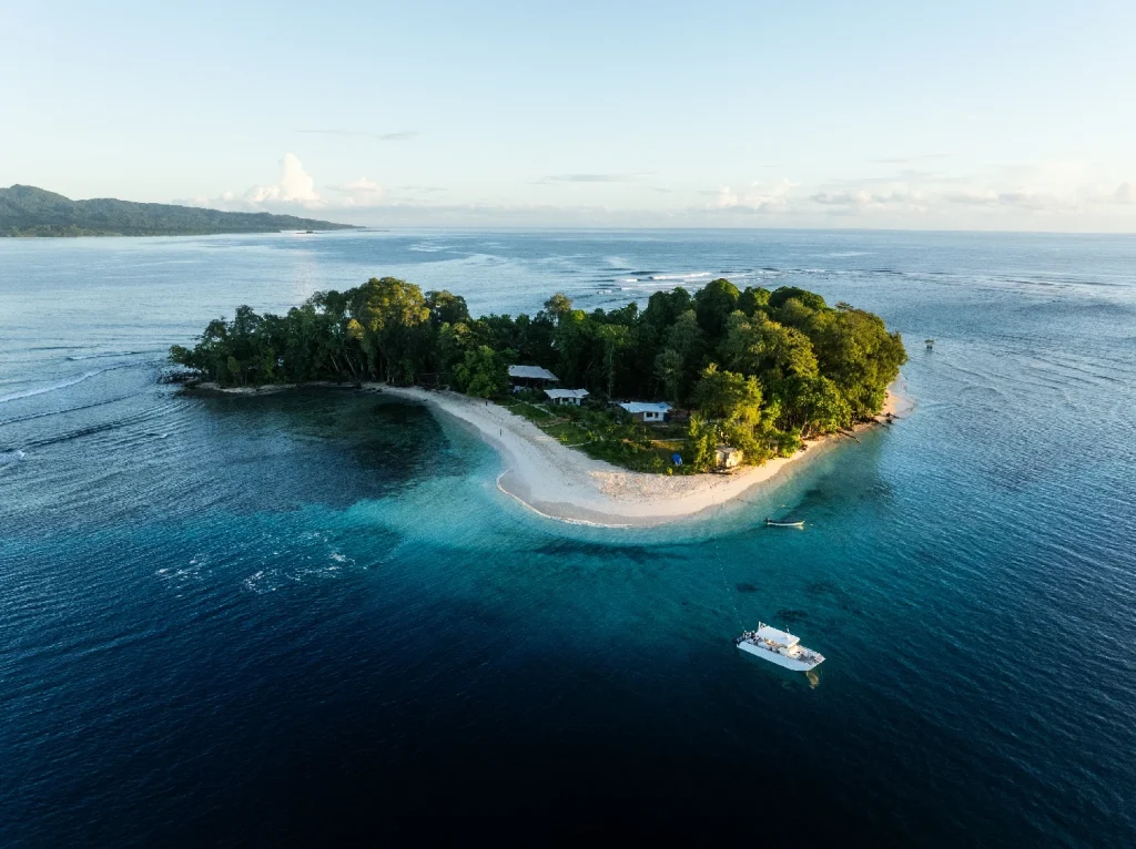 Aerial view of surfers at reef break with turquoise waters, Maldives – Atoll Travel